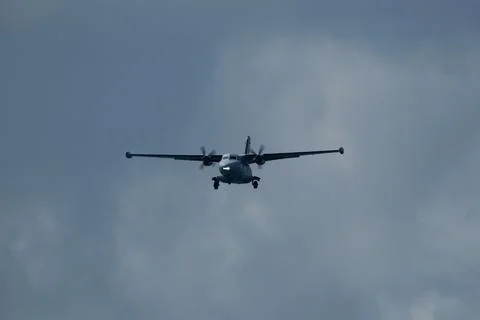 Airplane in the cloudy sky. Stock Photos