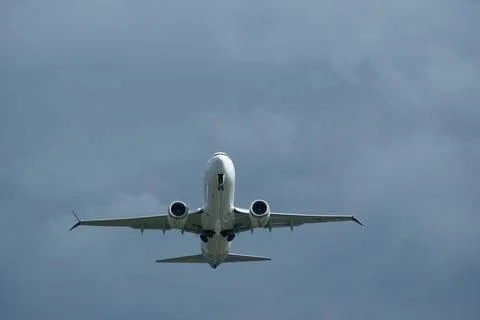 Airplane in the cloudy sky. Stock-Fotos