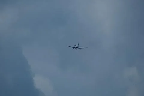 Airplane in the cloudy sky. Stock Photos