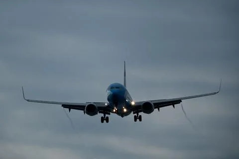 Airplane in the cloudy sky. Stock Photos