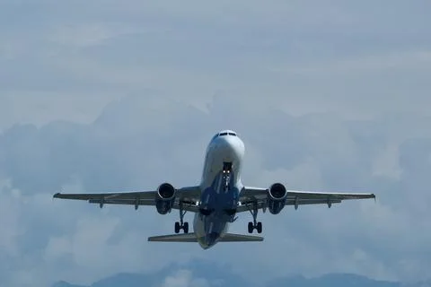 Airplane in the cloudy sky. Stock-Fotos