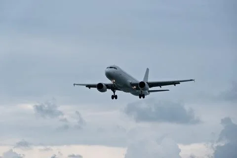 Airplane in the cloudy sky. Stock-Fotos