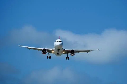 Airplane in the cloudy sky. Stock-Fotos