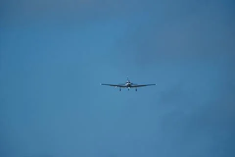 Airplane in the cloudy sky. Stock Photos