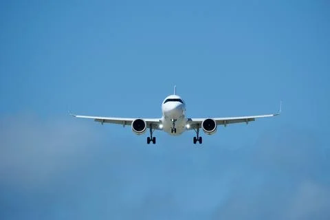 Airplane in the cloudy sky. Stock Photos