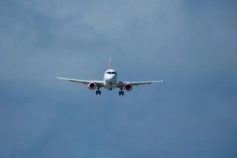 Airplane in the cloudy sky. Fotos de archivo