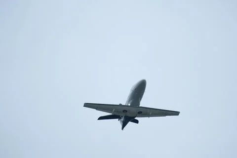 Airplane in the cloudy sky. Private plane in flight, Business jet in the sky. Foto stock