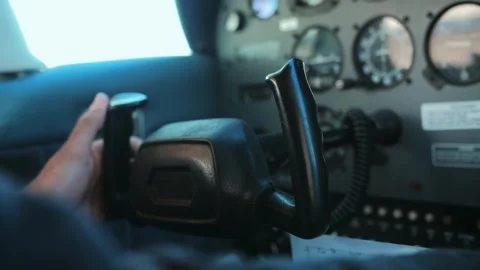 Airplane cockpit close up.Young man sitting at airplane cabin fly on the cloudy Stock Footage 253240799