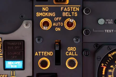 Airplane cockpit control switches for seatbelts and no smoking sign Stock Photos