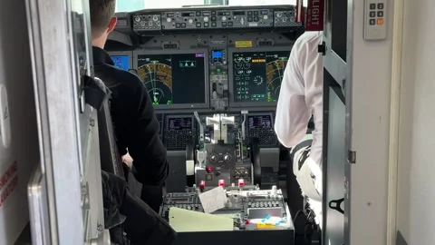 Airplane Cockpit with Pilots Preparing for Flight Stock Footage 333002736