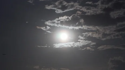 Airplane is crossing the blue sky with clouds in sunset light with blackout Stock Footage 108883976