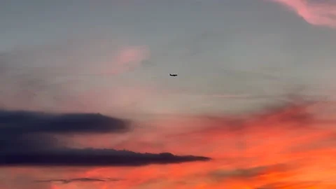 Airplane crossing over dramatic surreal sunset sky. Title Space. Post Dusk Stock Footage 233152648