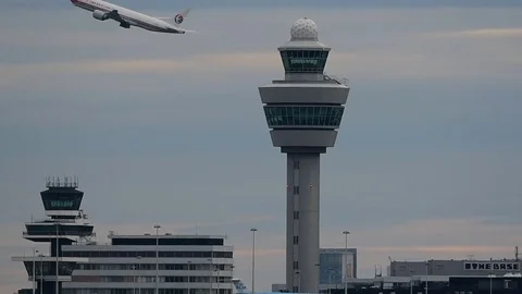 Airplane crossing tower Stock Footage 76571141