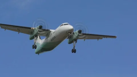 Airplane dash 8 wideroe arrival oslo airport slow motion passing by Video stock 108989949