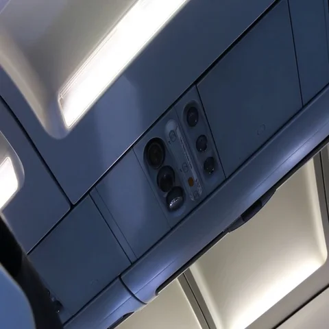Airplane dashboard panel above the heads of passengers Stock Footage 69546798