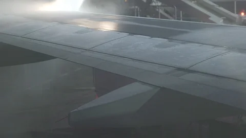 Airplane De-icing in winter Stock Footage 100084073