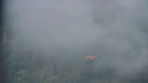 Airplane disappears into low clouds Stock Footage 93398551