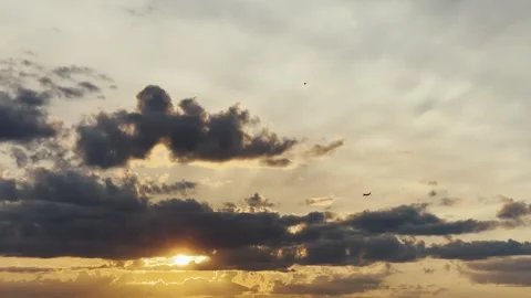 Airplane in Dramatic Sunset Featuring Beautiful Clouds Over the Distant Horizon Stock Footage 290051214