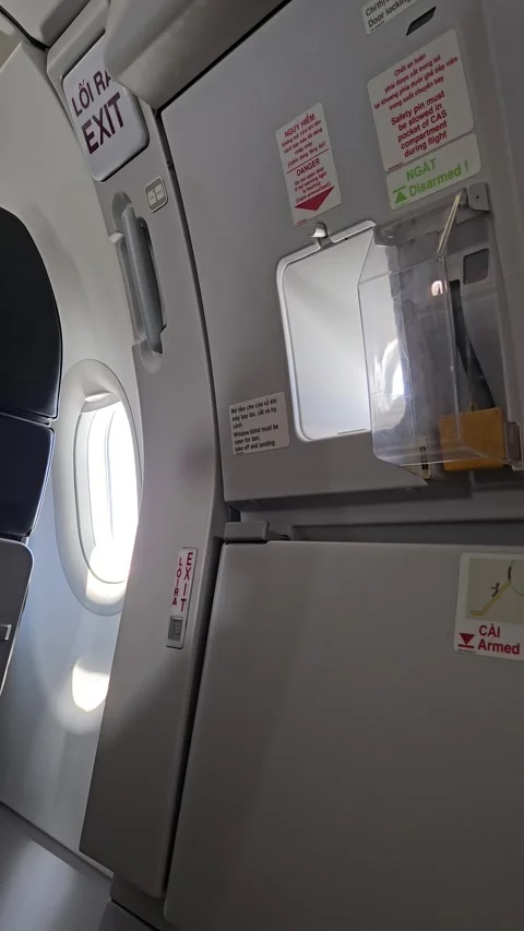 Airplane emergency exit door and window inside a passenger cabin. Stock Footage 341542937