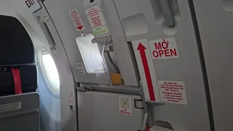 Airplane emergency exit door handle and safety instruction signs. Stock Footage 341542917