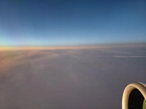 Airplane engine above cloud layer during sunrise flight over Europe 写真素材