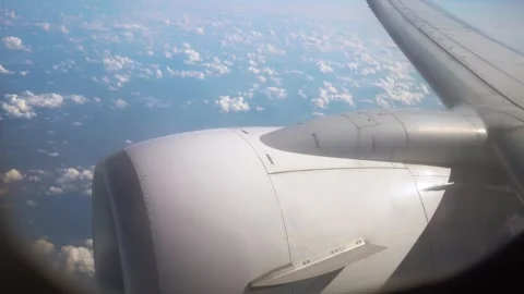 Airplane Engine Above Fluffy Clouds During Clear Sky on Sunny Day Stock Footage 315463521