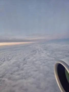 Airplane engine and cloudscape during early morning European flight 스톡 사진
