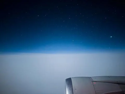 Airplane engine and starry sky with bright stars in blue sky during flight Stock Photos