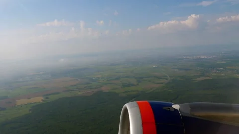 Airplane engine flying over green fields and landscape view Stock Footage 345986364