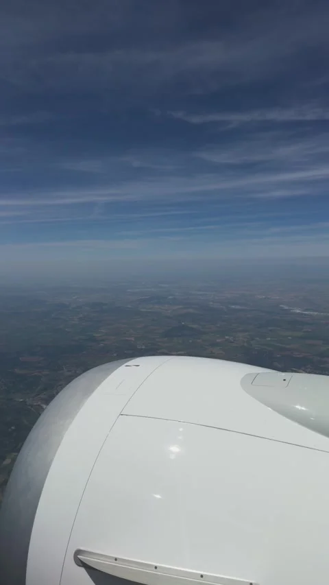 Airplane Engine View Above the Clouds During Flight with Expansive Blue Sky Video stock 338149141