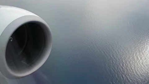 Airplane engine view while flying over the ocean Stock Footage 148496769