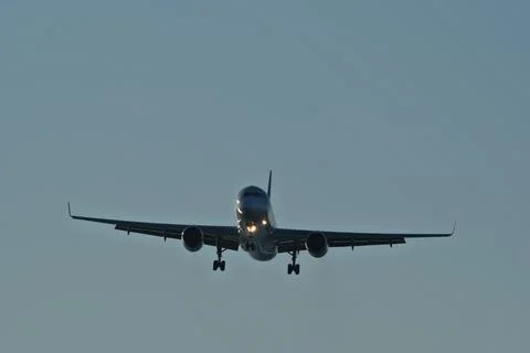 Airplane in the evening sky Stock Photos