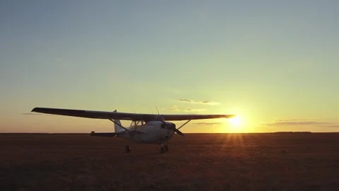 An airplane in a field at sunset. Video stock 279915234