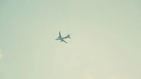 Airplane flies into clouds on grey sky Stock Footage 204997956