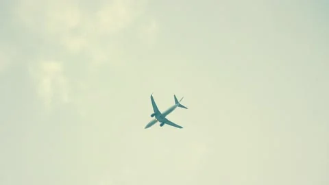 Airplane flies into clouds on grey sky Stock Footage 204998117