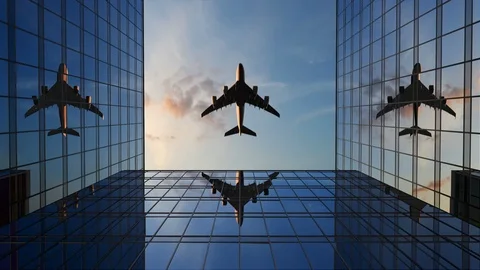 Airplane Flies Over Office Buildings Against a Time-Lapse Clouds Video stock 117097553