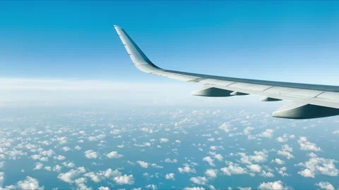 Airplane flight above clouds. View from window plane. Traveling by air, vacation Stock Footage 232748821