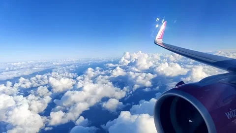 Airplane in Flight Above Fluffy Clouds with Rotating Turbine Stock Footage 295767587
