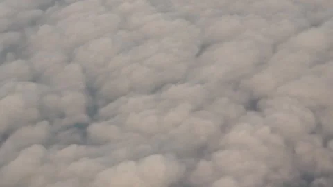 Airplane flight above thick cumulus clouds Stock Footage 344873827