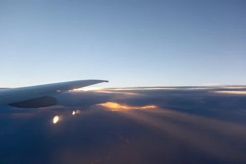 Airplane flight. Aircraft's wing and land seen through the illuminator Stock Photos