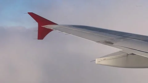 Airplane flight in the clouds, airplane wing close-up Stock Footage 246434882