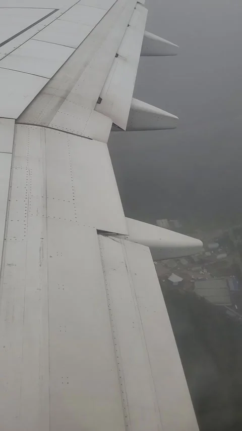 Airplane flight in the clouds. View from the airplane window. Vertical video Stock Footage 316573144