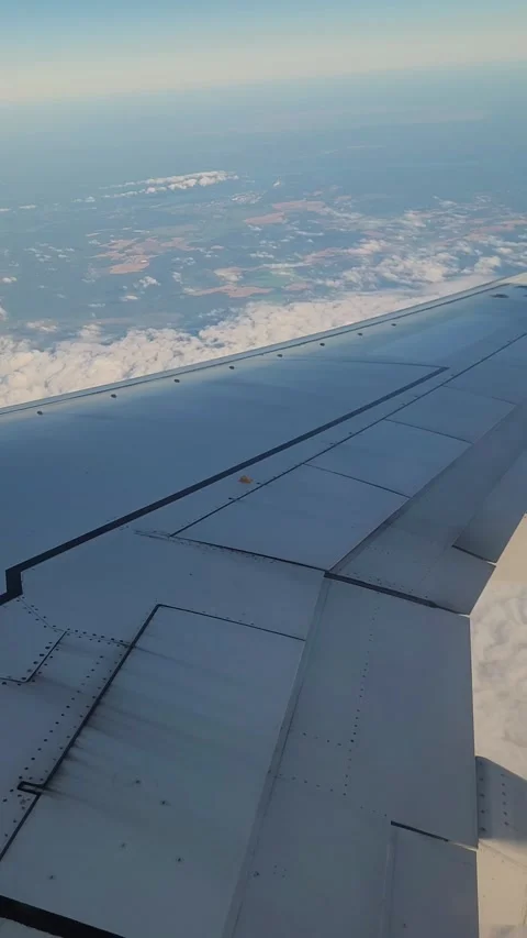 Airplane flight in the clouds. View from the airplane window. Vertical video Stock Footage 316573248