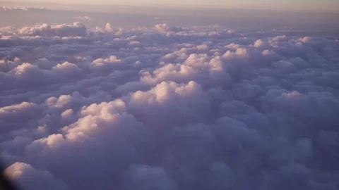 Airplane flight. Flying above the clouds with sunrise sky. View from the window Stock-Footage 87822038