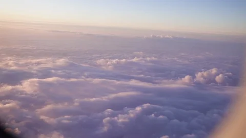 Airplane flight. Flying above the clouds with sunrise sky. View from the window Stock Footage 87822492