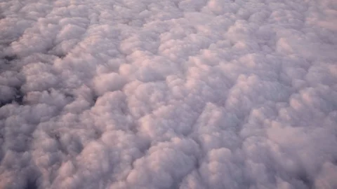 Airplane flight. Flying above the clouds with sunrise sky. View from the window Stock Footage 87826159