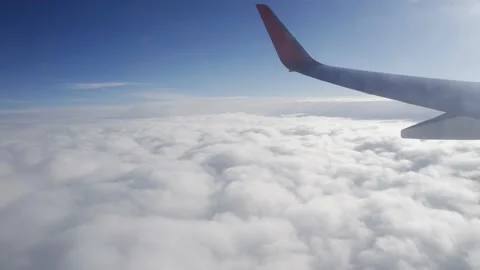 Airplane flight. Flying above the clouds. View from the window of the plane Stock Footage 181887830