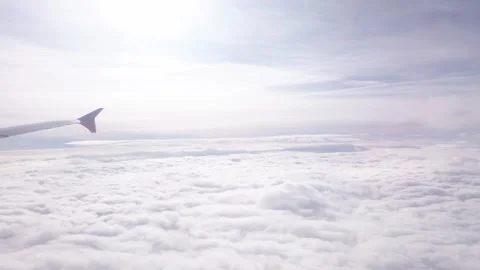 Airplane flight high up over white cloud and sunbeams at sky Stock Footage 308820952