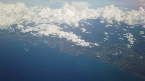 Airplane Flight Jakarta to Manado. Wing of an Airplane Flying Above the Clouds Stock Footage 129921253
