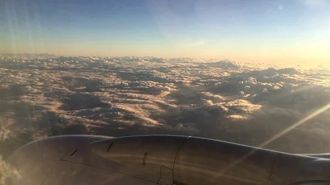 Airplane flight A Jet Plane Flying over sunset clouds View From Window Stock Footage 105470391